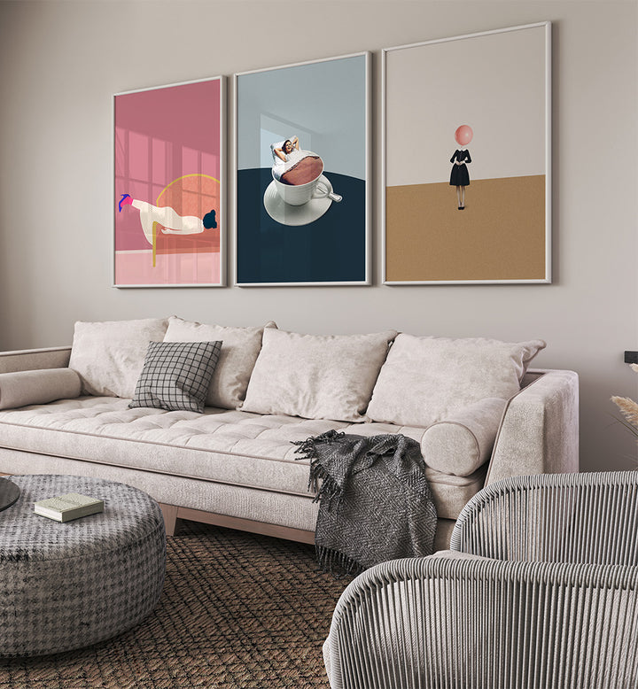 Living room with a sofa, ottoman, and three framed artworks on the wall.