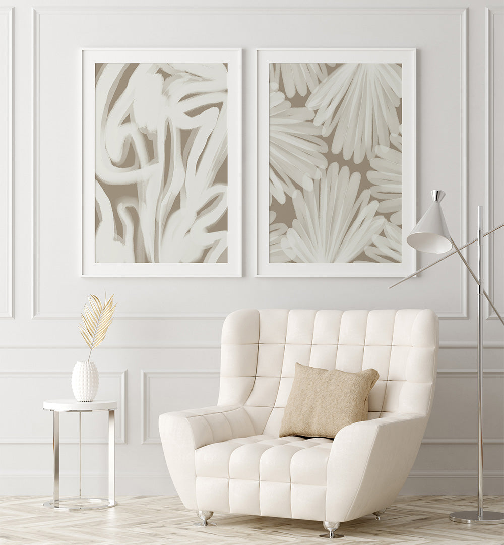 White armchair in a room with abstract wall art and a side table.