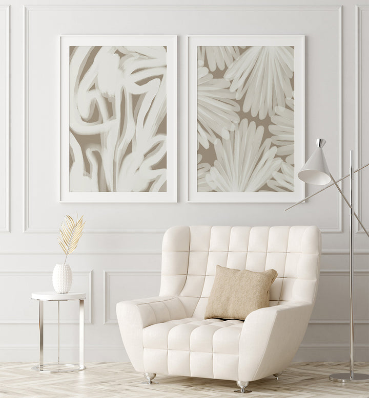 White armchair in a room with abstract wall art and a side table.