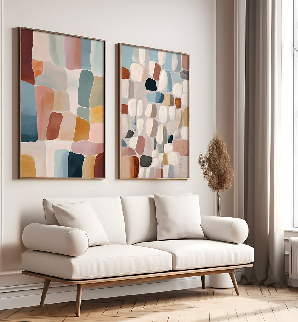 Modern living room with a white sofa, abstract art on the wall, and a vase.