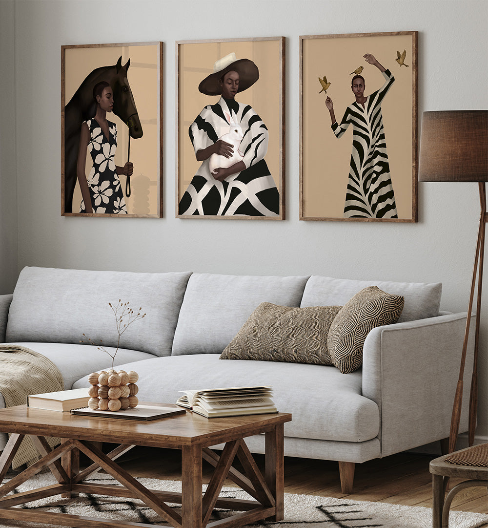Living room with a gray sofa, wooden coffee table, and three framed portraits on the wall.