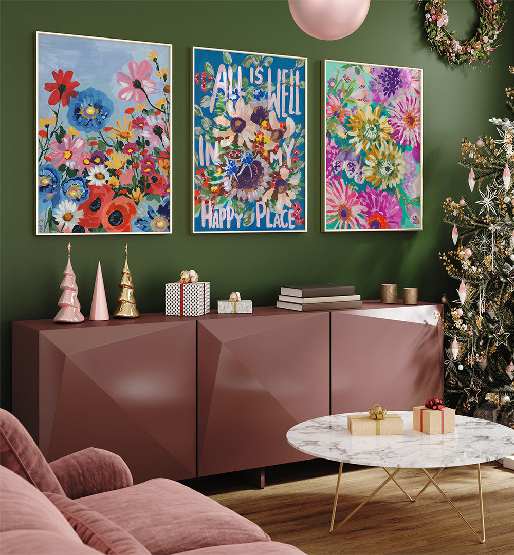 Living room with floral posters, a Christmas tree, and decorative items on a green wall.