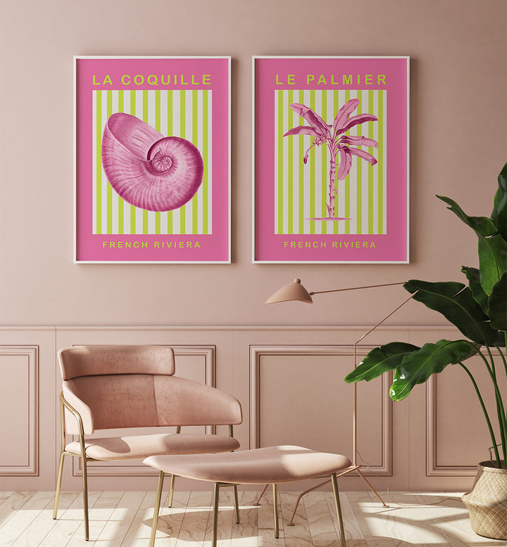 Two framed posters of a shell and palm tree on a wall with a chair and plant in the foreground.