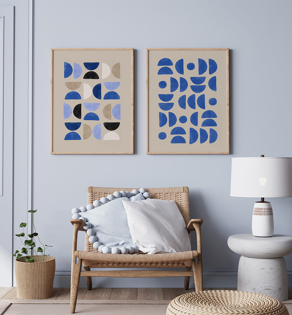 Modern living room with abstract wall art, wicker chair, and lamp.