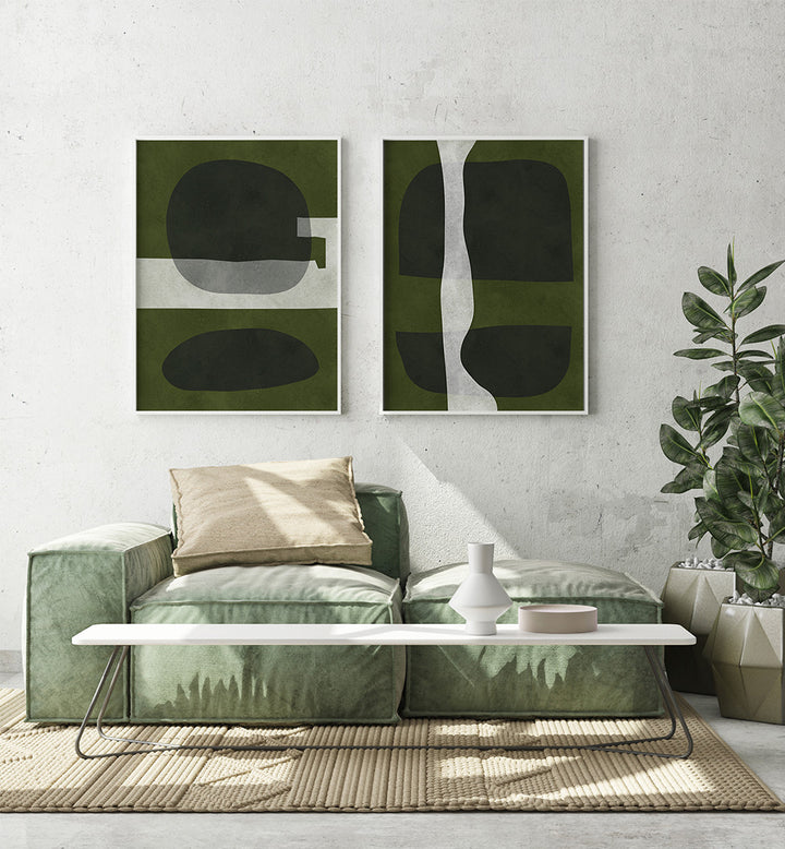Modern living room with abstract green and black paintings on the wall, a green sofa, and a white coffee table.