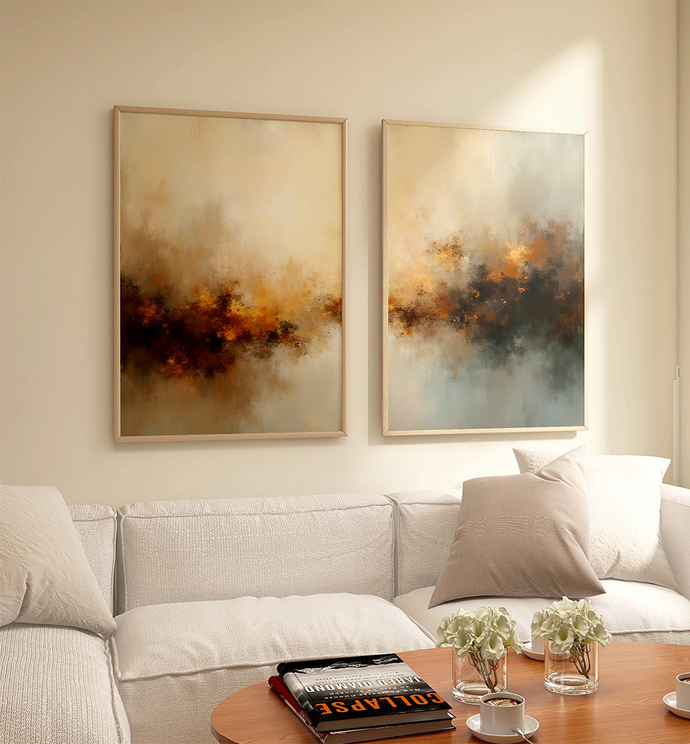 Two abstract paintings on a wall above a sofa with a coffee table in the foreground.