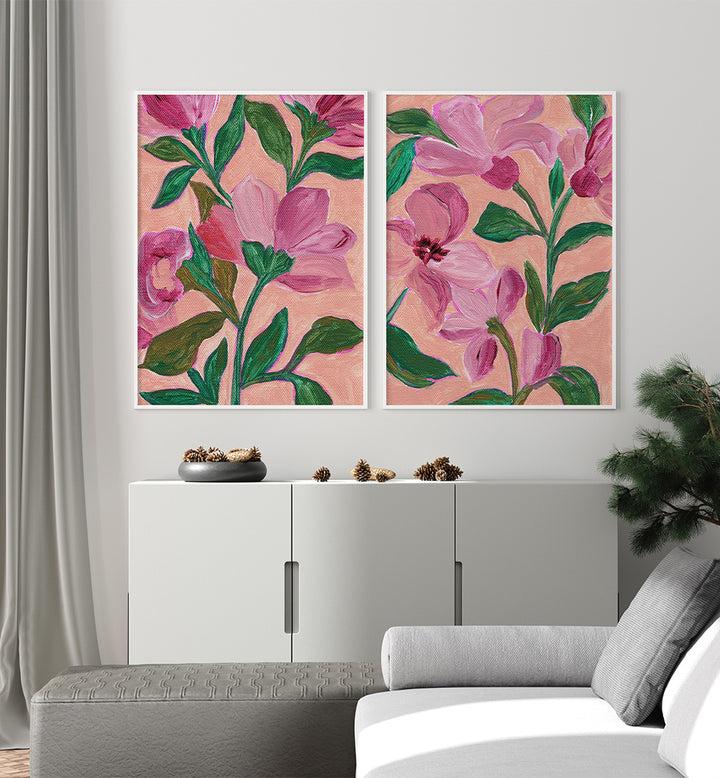 Two floral paintings on a wall above a white cabinet.