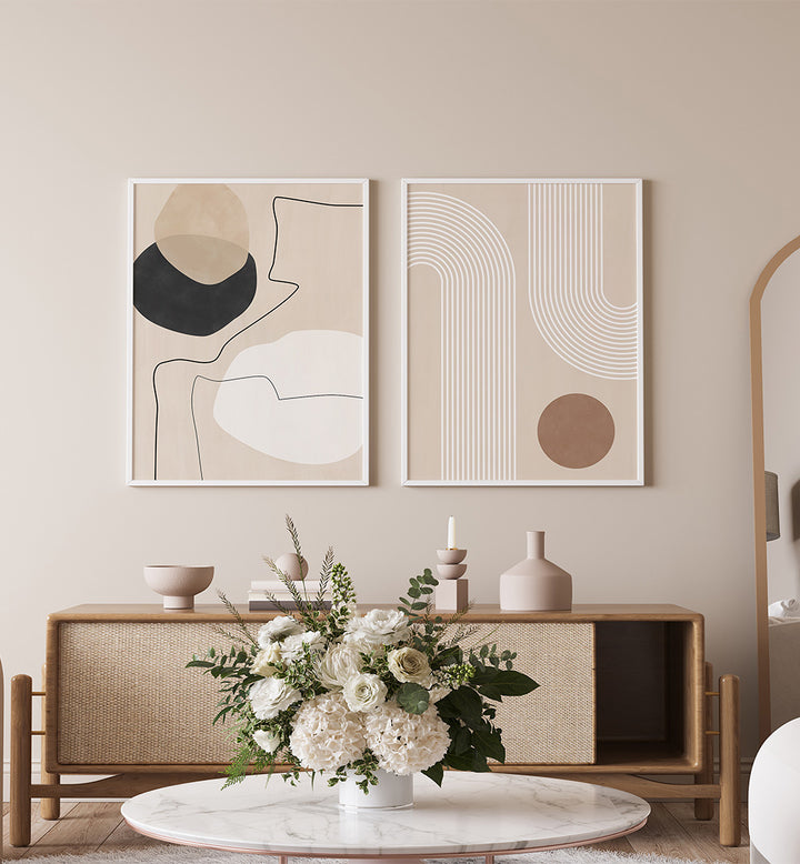 Modern interior with abstract art, wooden sideboard, and floral arrangement.