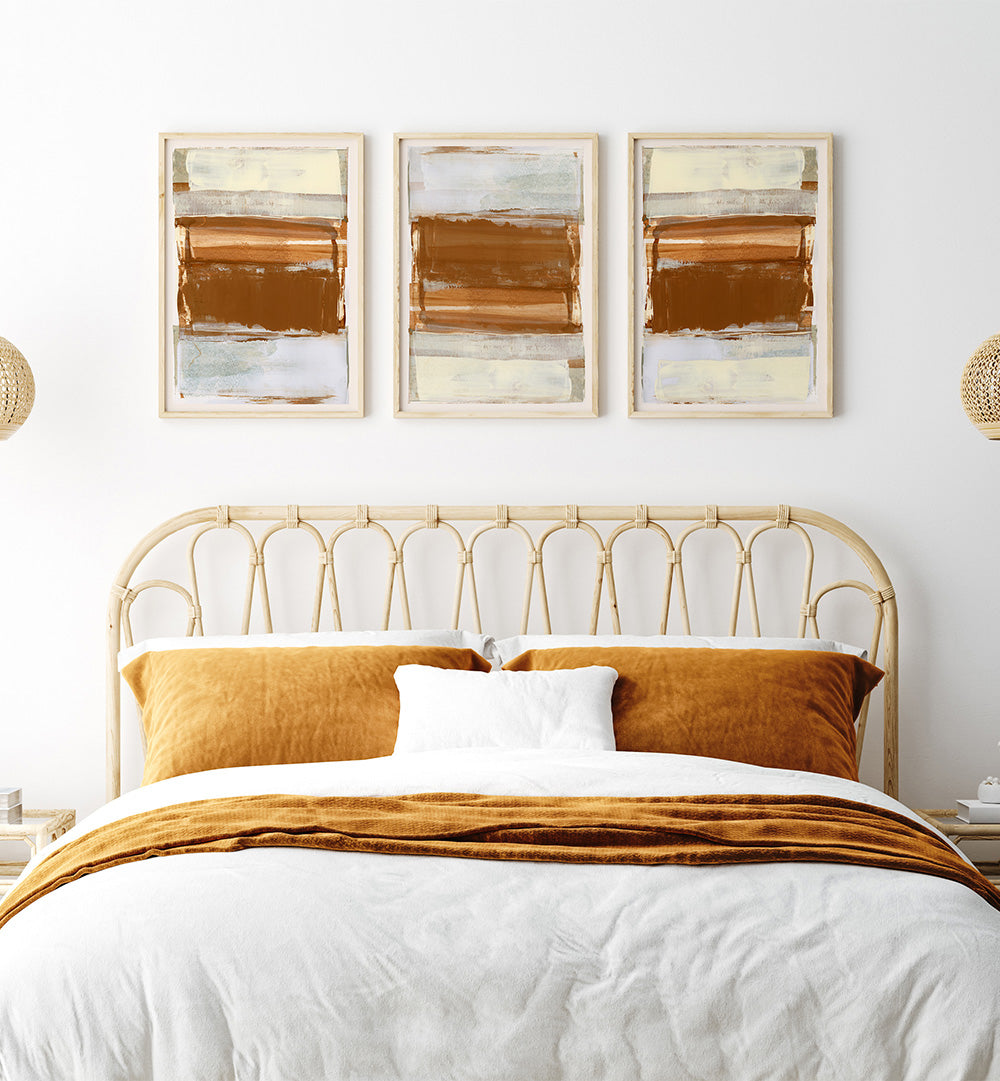 Bedroom with a gold headboard, white bedding, and abstract art on the wall.