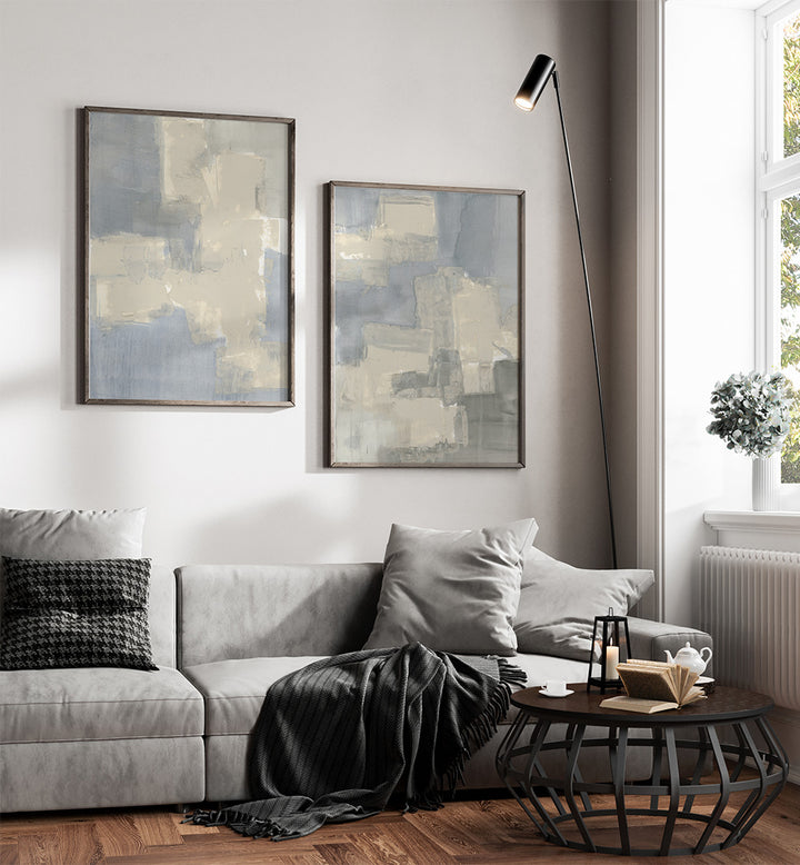 Modern living room with gray sofa, abstract art, and a floor lamp.