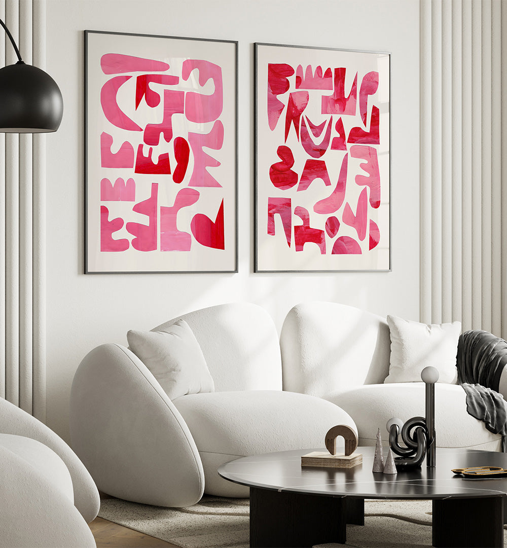 Modern living room with white sofa, abstract pink art on the wall, and a black coffee table.