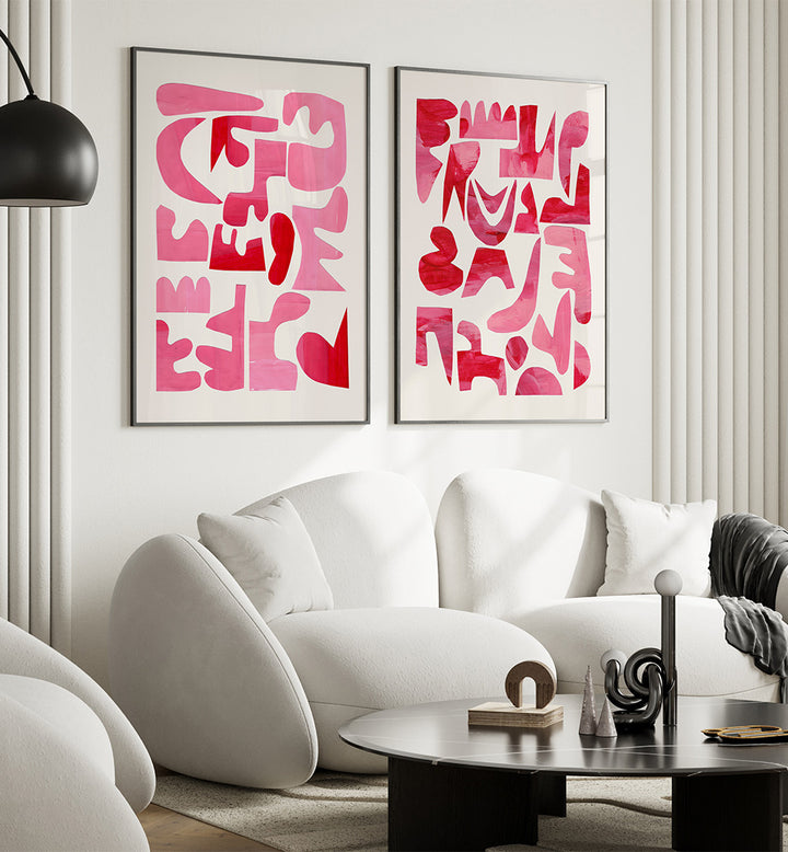 Modern living room with white sofa, abstract pink art on the wall, and a black coffee table.