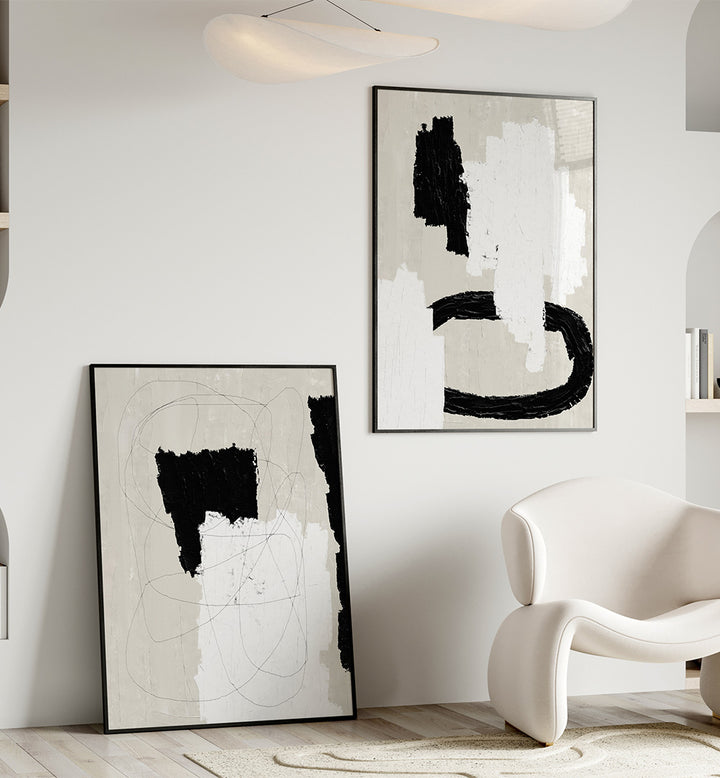 Modern interior with abstract black and white artworks on a wall.