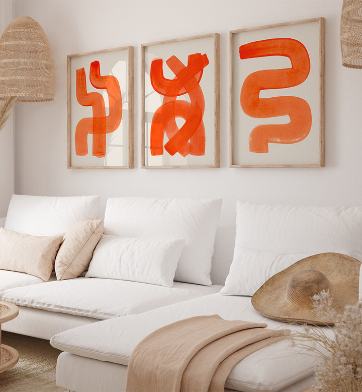 Modern living room with a white sofa, abstract orange art, and natural decor elements.