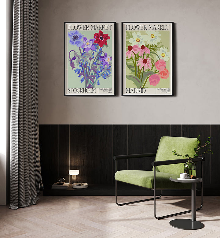 Two floral posters on a wall above a green chair in a room.