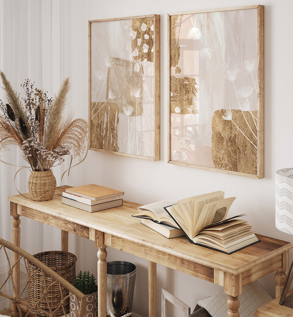 Wooden console table with books and a vase, framed artwork on the wall.