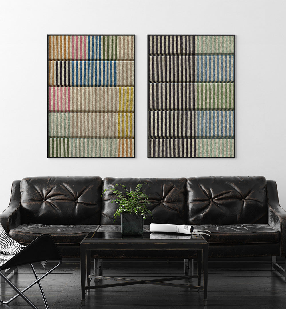 Two abstract wall art pieces above a black leather sofa in a living room.