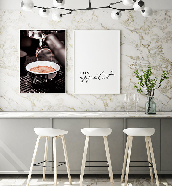 Modern kitchen interior with marble wall, bar stools, and framed artwork.