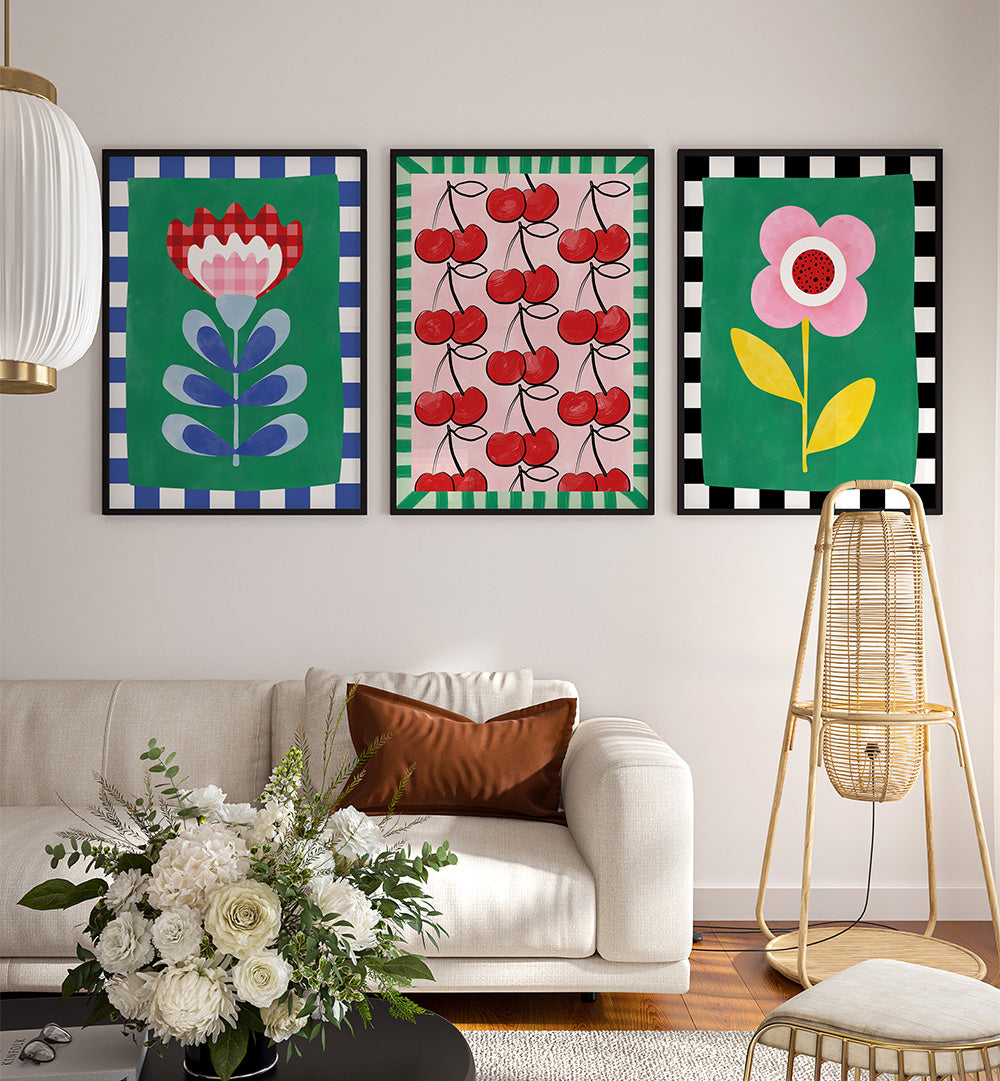Colorful floral and fruit-themed wall art above a white sofa in a living room.