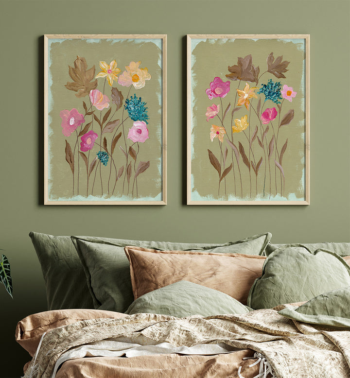 Two floral paintings on a wall above a bed with green and brown bedding.