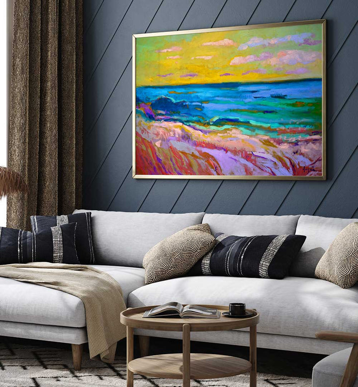 Framed COASTAL  SUNSET , LANDSCAPE PAINTINGS of vibrant shoreline and twilight hung above a modern living room sofa