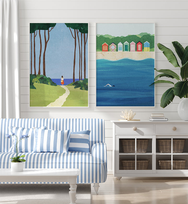 Living room with a blue and white striped sofa, two wall paintings, and a white cabinet.