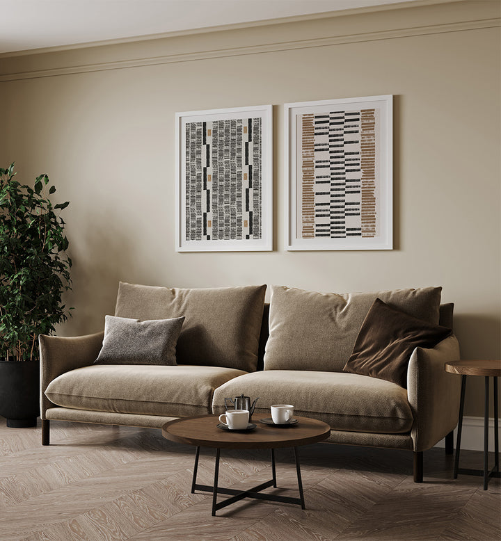 Beige sofa in a living room with abstract art on the wall and a small table with items.