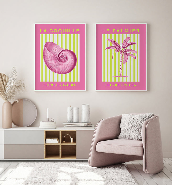 Two framed posters of a shell and palm tree on a wall above a modern armchair.
