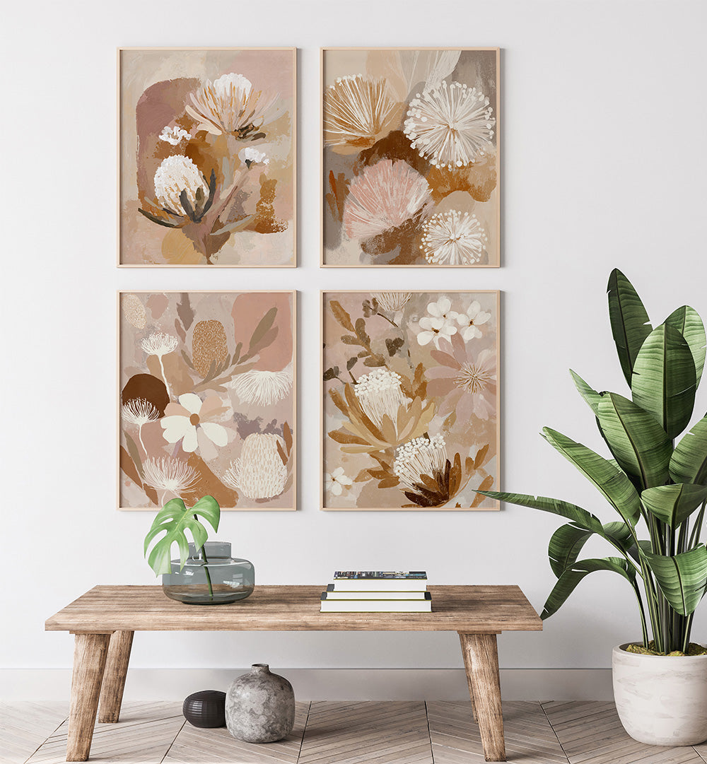 Floral wall art prints on a white wall with a wooden table and plants.