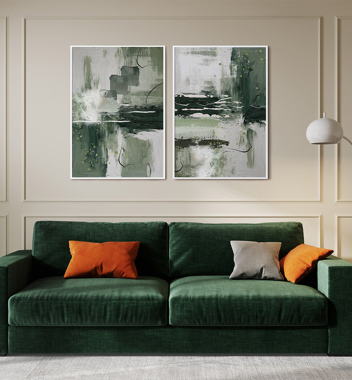 Green sofa with orange and gray cushions in front of abstract wall art