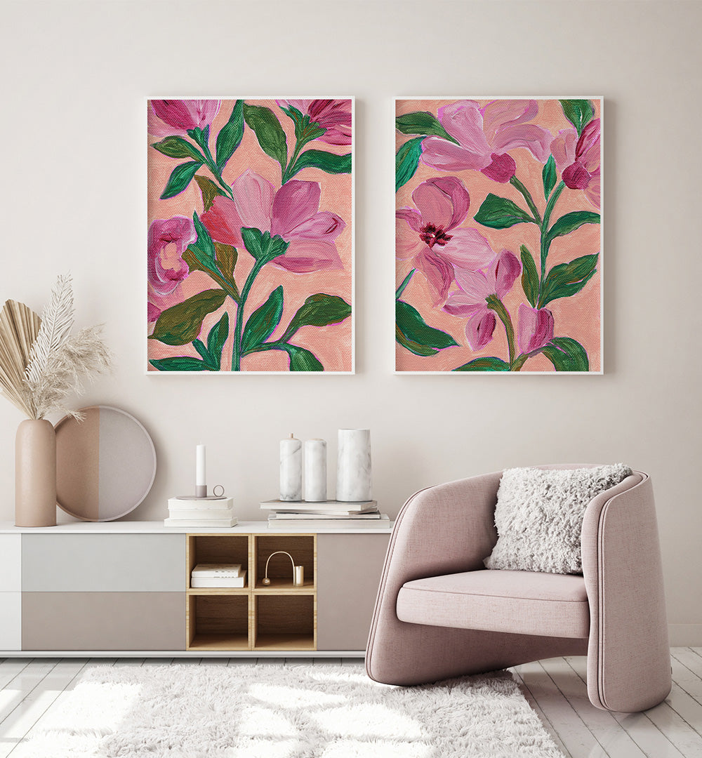 Two floral paintings on a wall above a modern living room setup.