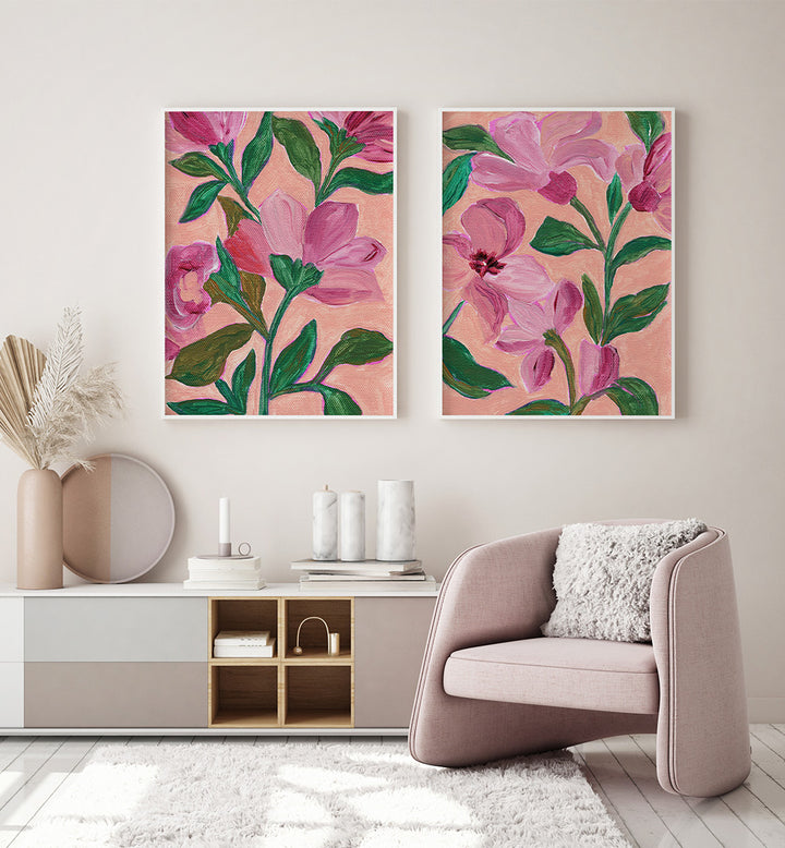 Two floral paintings on a wall above a modern living room setup.