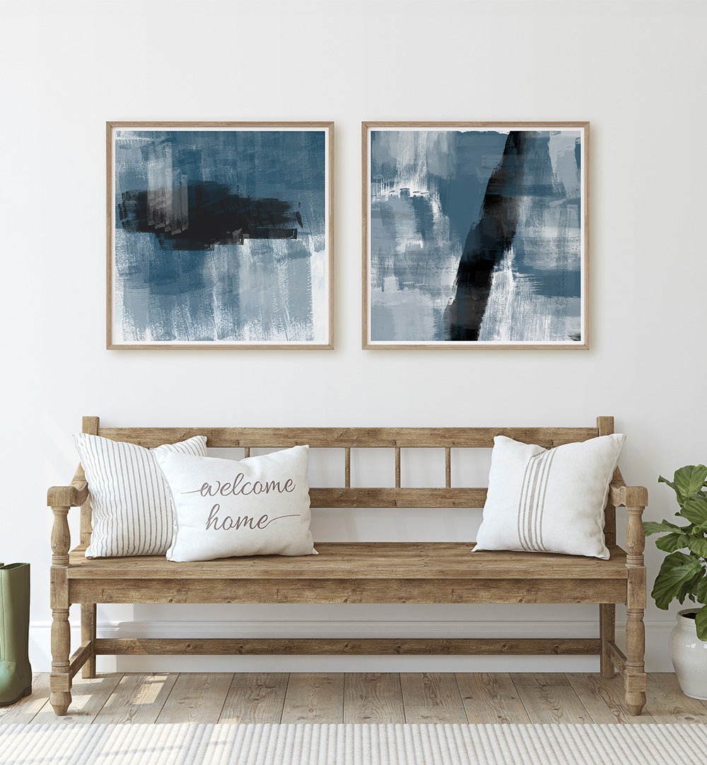 Wooden bench with pillows and abstract art on a white wall