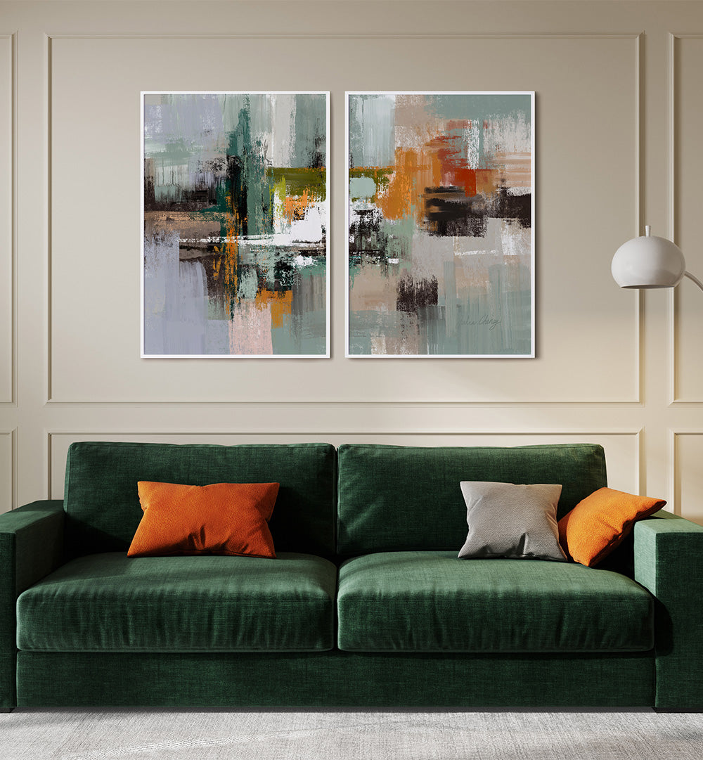 Green sofa with orange and gray cushions in front of abstract wall art