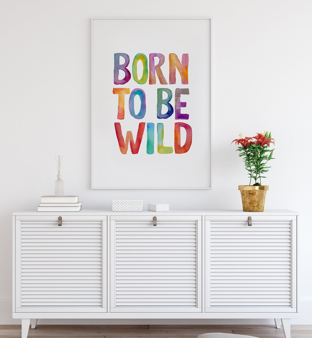 Colorful "BORN TO BE WILD, QUOTES" typography poster by Brett Wilson, perfect for inspiring adventure in any space.