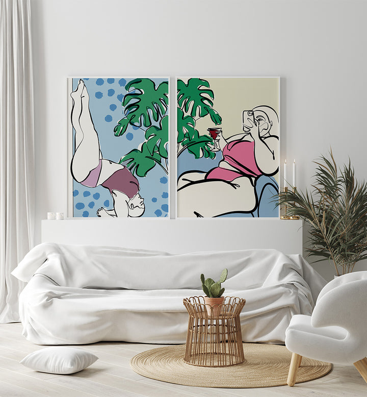 Two abstract art prints on a wall above a white sofa in a living room.
