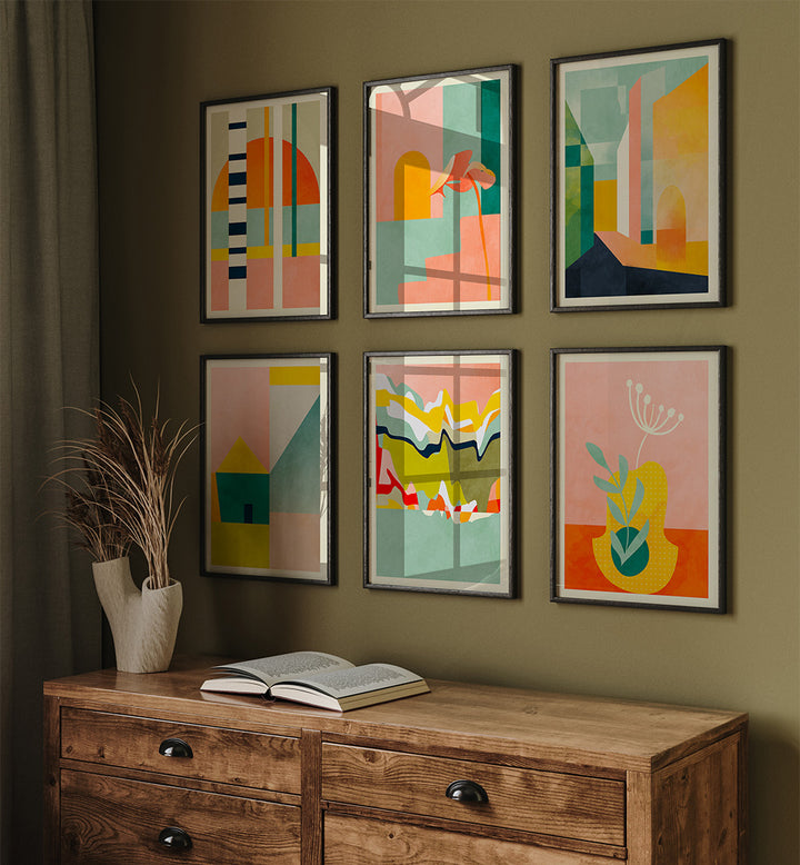 Set of six abstract framed artworks on a wall above a wooden sideboard with an open book.