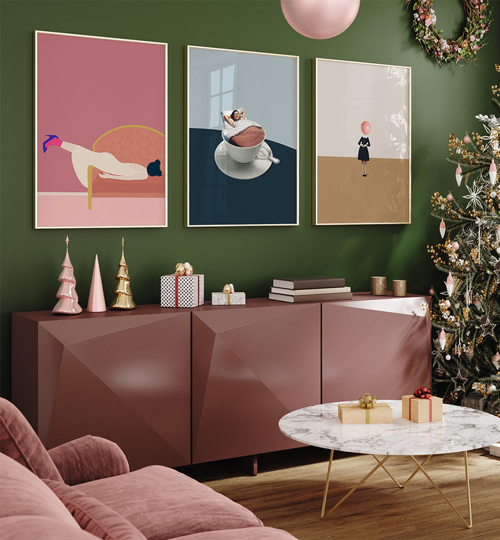 Living room with decorative posters on a green wall, a pink sideboard, and a Christmas tree.