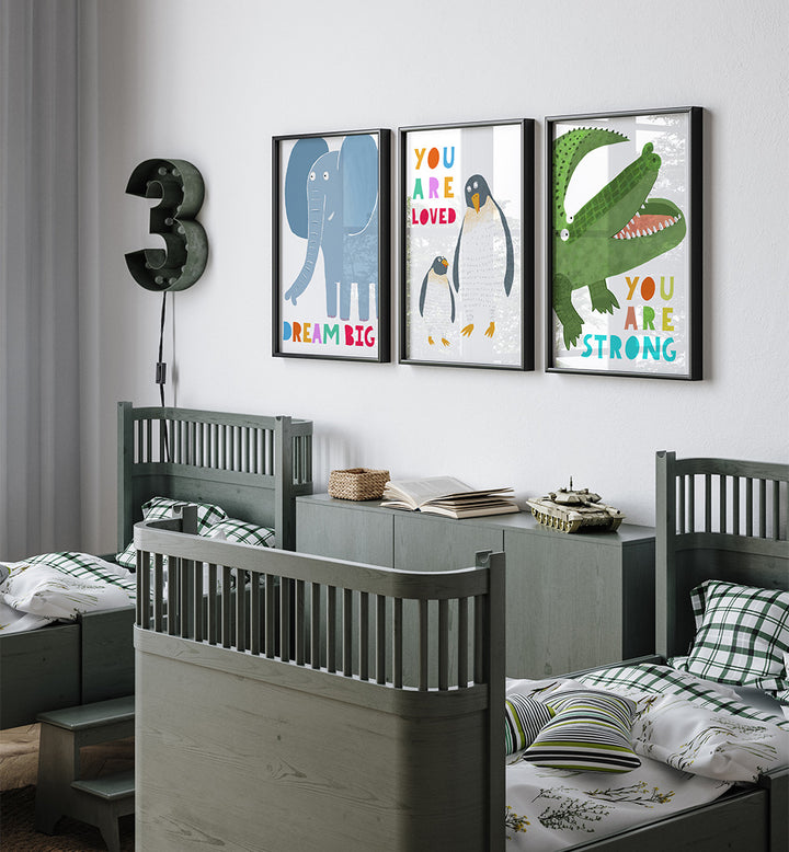 Children's bedroom with gray beds, colorful wall art, and a decorative number 3 on the wall.