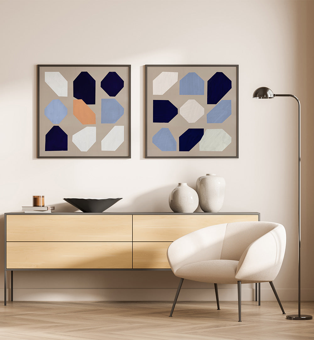 Modern interior with a wooden sideboard, white chair, and abstract wall art.