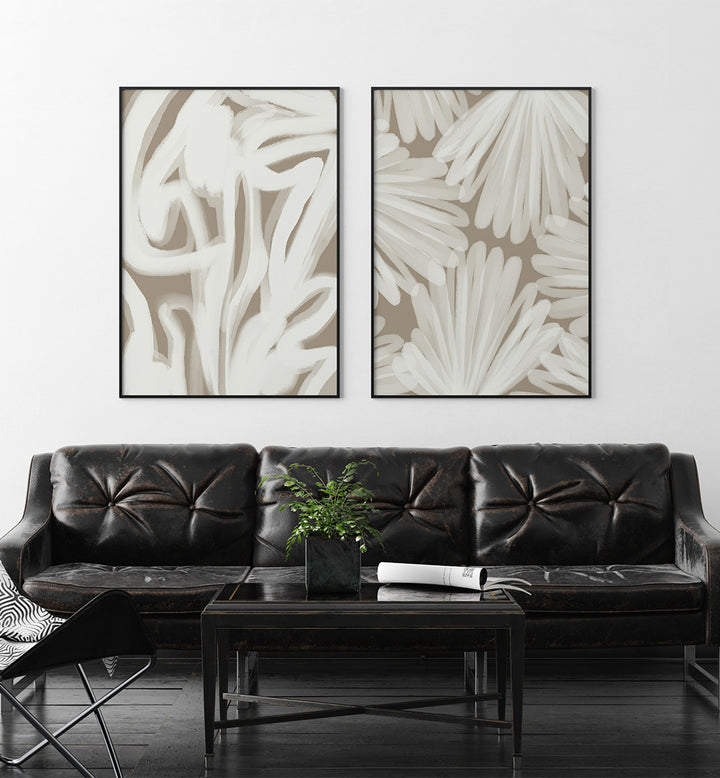 Modern living room with a black leather sofa and abstract wall art.