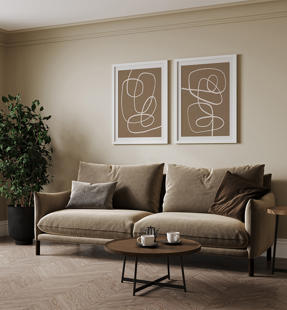 Beige sofa in a living room with abstract wall art and a coffee table.