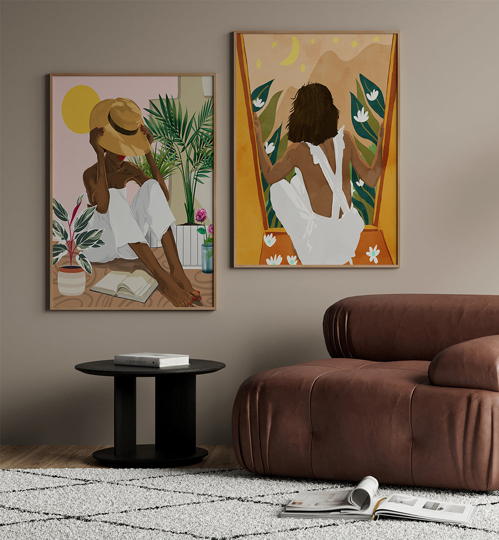 Living room with two framed artworks on the wall and a brown sofa.