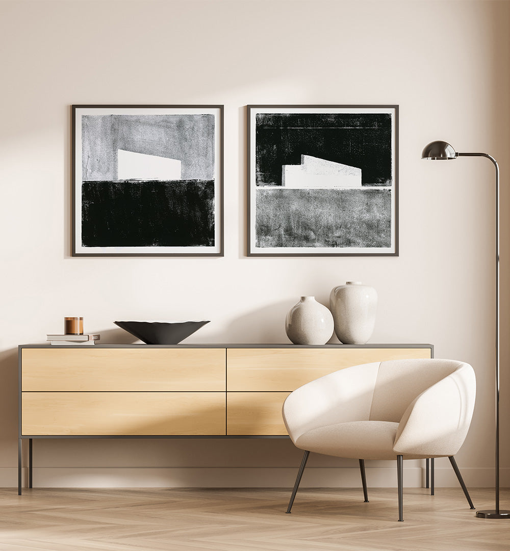 Modern living room with a wooden sideboard, white armchair, and abstract art on the wall.