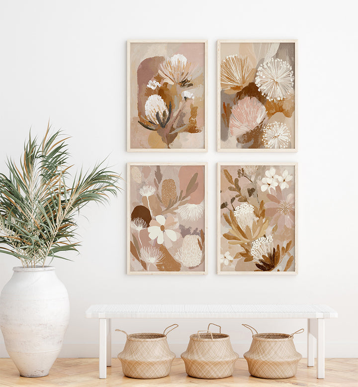 Floral art prints on a wall with a vase and baskets on a table below.