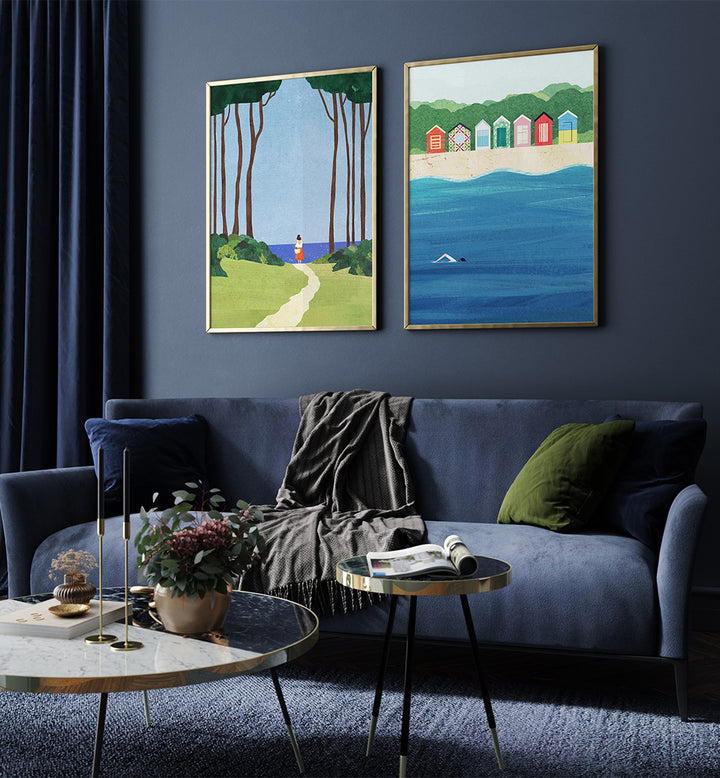 Living room with a blue sofa, two framed artworks on the wall, and decorative items on tables.