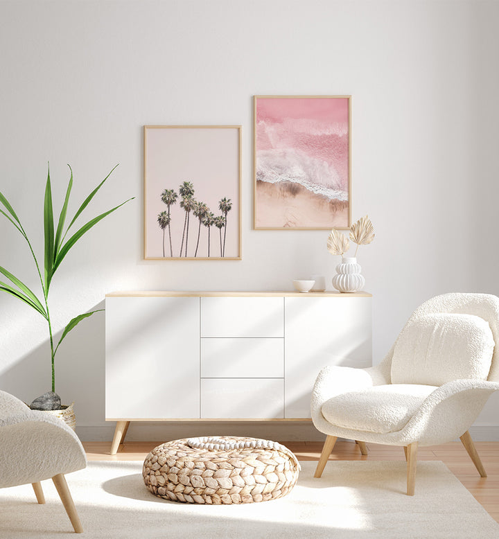 Modern living room with white furniture, a plant, and wall art.