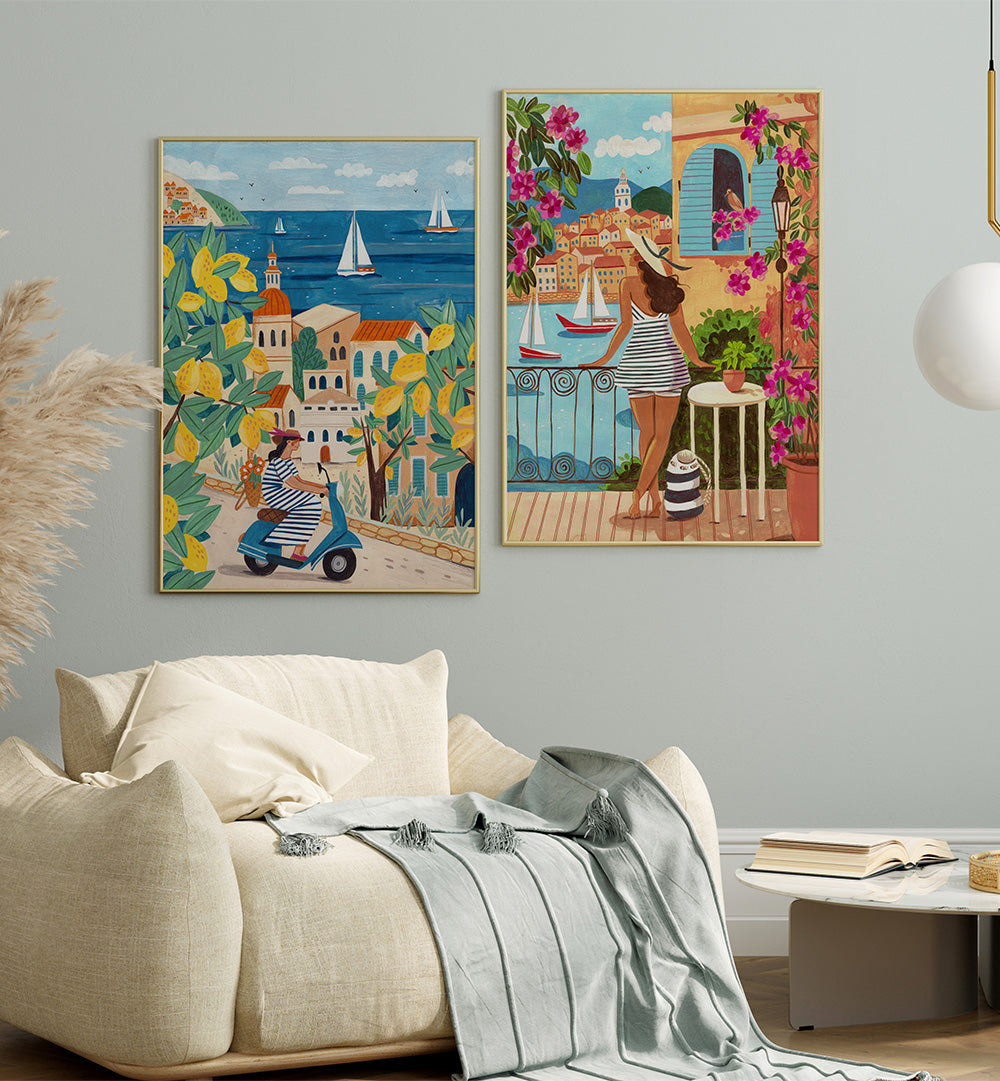 Two colorful wall art prints of Mediterranean scenes in a living room.