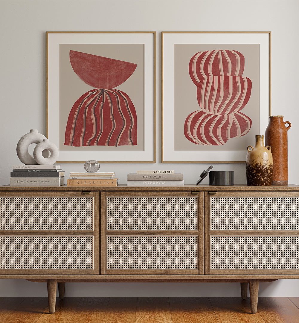Wooden cabinet with abstract art and decorative items against a white wall