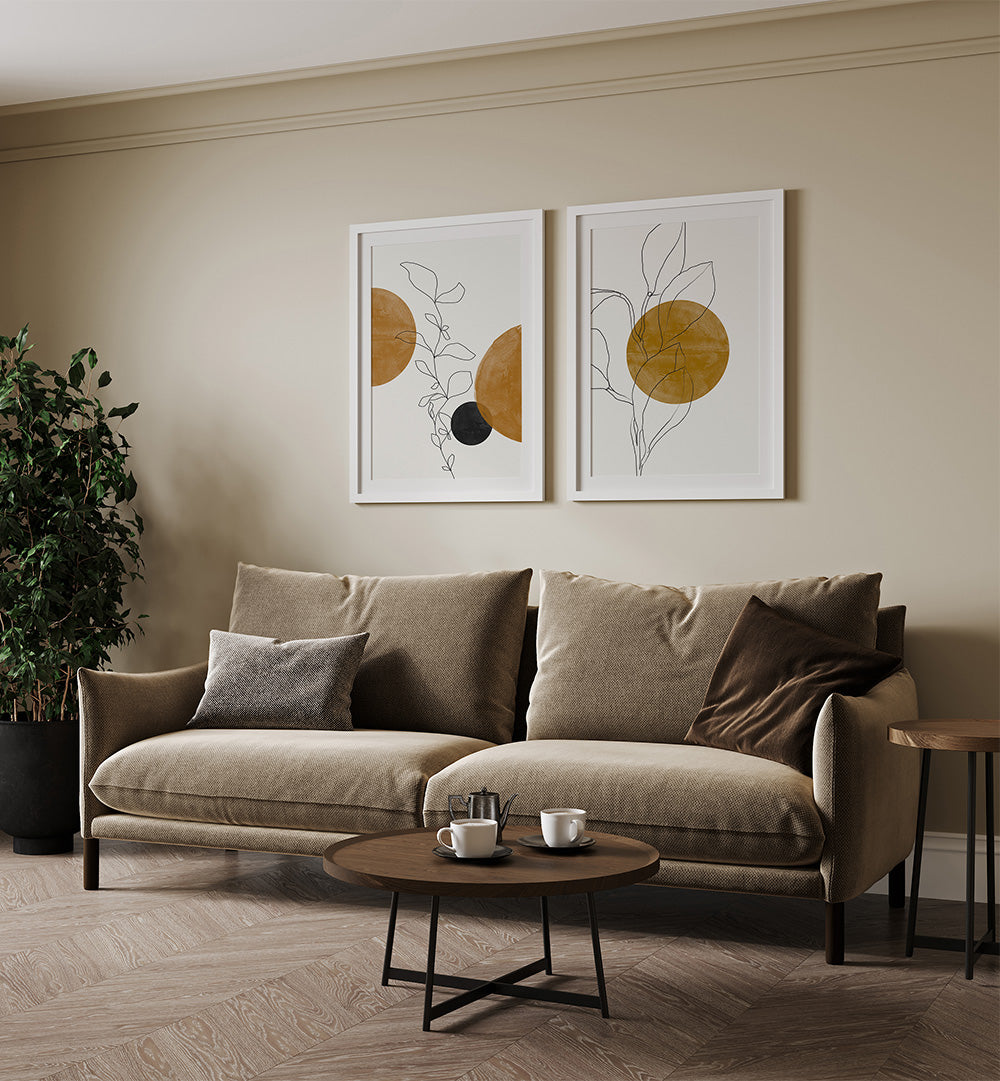 Beige sofa in a living room with decorative wall art and a coffee table.